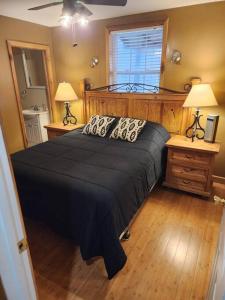 a bedroom with a large bed and two night stands at 2 bed, 1.5 bath cottage across from Watauga Lake in Butler