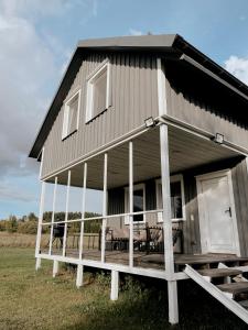 a large house with a porch and a deck at HYGGE Sauna&Fishing House 