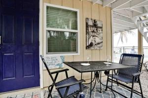 a porch with a table and chairs and a window at Gorgeous Waterfront! Kayaks-pool & Beach-rm in Englewood