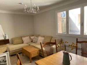 a living room with a couch and a table at Appartement Familial in Marignac