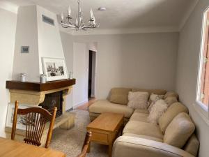 a living room with a couch and a fireplace at Appartement Familial in Marignac