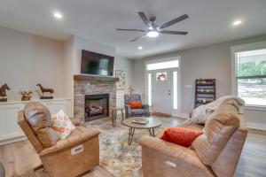 a living room with two chairs and a fireplace at Secluded Barboursville Home with Covered Porch! in Barboursville