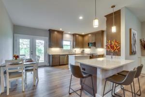 a kitchen with a island with chairs and a table at Secluded Barboursville Home with Covered Porch! in Barboursville