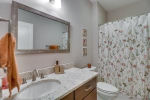 a bathroom with a sink and a shower curtain at Secluded Barboursville Home with Covered Porch! in Barboursville +18 photos