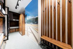 a hallway with wooden doors and a view of a building at MISTO capsule hotel in Kyiv