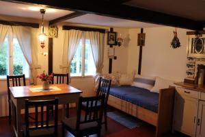 a living room with a bed and a table and chairs at Ubytování Roubenka in Koberovy