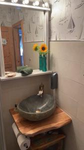 a bathroom with a stone sink and a mirror at Ferienhaus „Schöne Aussicht“ in Hasselberg