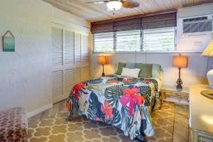 a bedroom with a bed in a room with windows at Sunny Waianae Condo with Ocean View! in Waianae