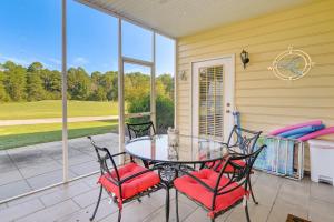 a patio with a glass table and chairs on a porch at Myrtle Beach Condo with Community Perks in Myrtle Beach