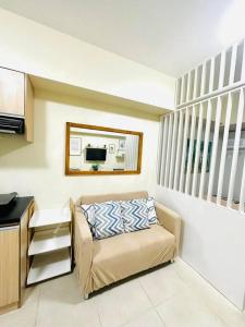 a small living room with a couch and a microwave at Avida Riala Cebu: Your Home in Cebu City