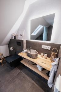 a bathroom with a sink and a mirror at Eifellodge - am roten Sandberg in Prüm