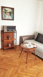 Café Rudi Living في بارشينيس: غرفة معيشة مع أريكة وطاولة
