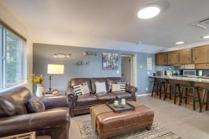 a living room with leather furniture and a kitchen at Bremerton Vacation Rental with Hot Tub and Lake Access in Belfair +34 photos