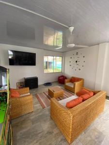 a living room with couches and a flat screen tv at Casa quinta Aluna in Carmen de Apicalá