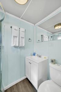 a bathroom with a shower and a sink and a toilet at Eagles Nest Motel Unit 2 in Escanaba