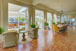 an empty lobby with chairs and tables and windows at The Historic Cavalier Hotel and Beach Club Autograph Collection in Virginia Beach