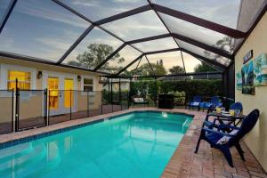 a swimming pool with a glass roof over it at Venice Island Private Pool Home Wows! Beach! Po in Venice