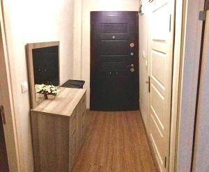 a hallway with a black door and a wooden floor at Апартаменты для семьи (№4) in Yalova
