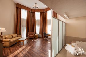 a living room with a couch and a table at Coast Hillcrest Hotel in Revelstoke