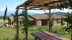 a stone house with a bench in front of it at Agricampeggio Madonna di Pogi in Bucine