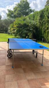 a blue ping pong table sitting on a patio at Villa Torrent Costa Brava, con piscina privada! in Pals