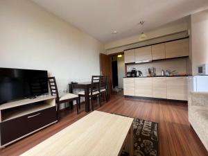 a living room with a kitchen and a dining room at Regnum Bansko in Bansko
