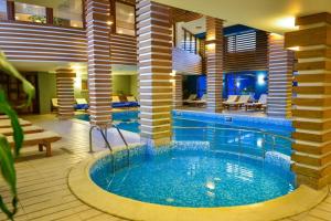 a large swimming pool in a hotel room with a pool at Regnum Bansko in Bansko