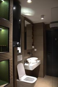 a bathroom with a toilet and a sink at Elite Space in Niš +16 photos