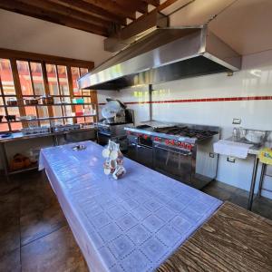 a kitchen with a table in the middle of it at La Casa Baez in Pátzcuaro