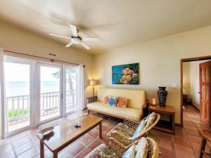 a living room with a couch and a ceiling fan at Sapphire Beach Resort in Basil Jones