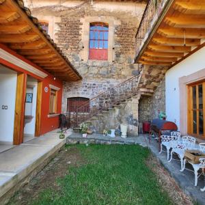 a stone house with a patio with a table and chairs at La Casa Baez in Pátzcuaro