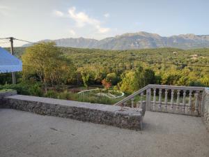 a balcony with a bench and a view of mountains at Talija in Kotor