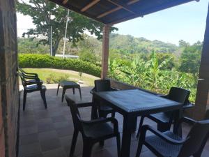 a table and chairs on a patio with a view at Quiero finquear in Manizales
