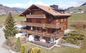 an aerial view of a large wooden house at Chalet Apartment Serenity Lodge in Charmey