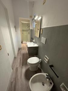 a bathroom with a white toilet and a sink at B&B il Rio in Anacapri