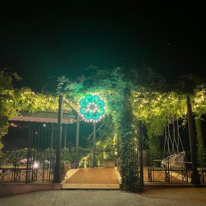 a garden gate with lights at night at Villa Euchelia in Castrocielo