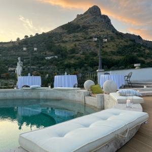 a swimming pool with a mountain in the background at Villa Euchelia in Castrocielo