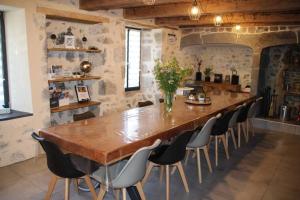 a large wooden table and chairs in a room at Location maison Bourboule in Murat-le-Quaire