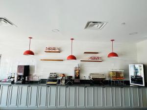 a hair salon with red pendant lights on the wall at Comfort Inn Emporia in Emporia