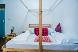 1 dormitorio con 1 cama con dosel en Banana Farm Eco Hostel en Arusha