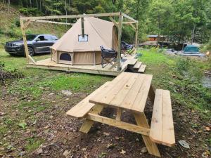 a tent with a picnic table and a bench at Glamping tent in Butler