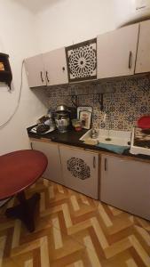 a kitchen with a stove and a counter top at Riad Khira in Agadir
