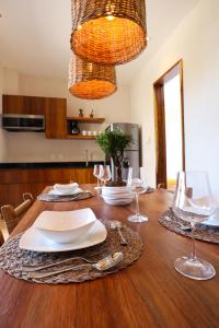 a dining room table with plates and wine glasses at Akbal Tulum in Tulum