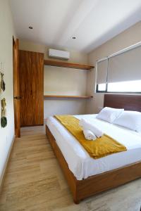 a bedroom with a large bed and a window at Akbal Tulum in Tulum