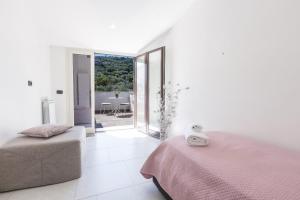 a white room with two beds and a balcony at La Terrazza sul Golfo in Sorrento