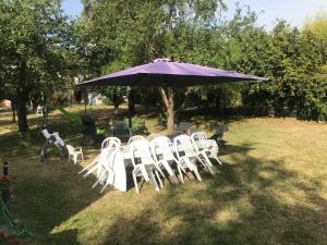 a group of white chairs under a purple umbrella at Chelles - Paris - Disneyland Marne la vallée in Chelles