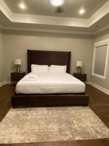 a bedroom with a large bed with two night stands at The Haven at Estuary in Huntsville