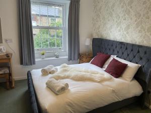 a bedroom with a bed with towels on it at The Sun Inn in Hexham