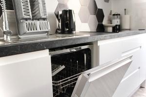 an open oven in a kitchen with a counter top at Hackney Haven! in London