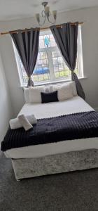 a bedroom with a bed with a large window at Therence Accommodations can sleep up to 4 Guests in Chesterton, Stoke on Trent in Longport